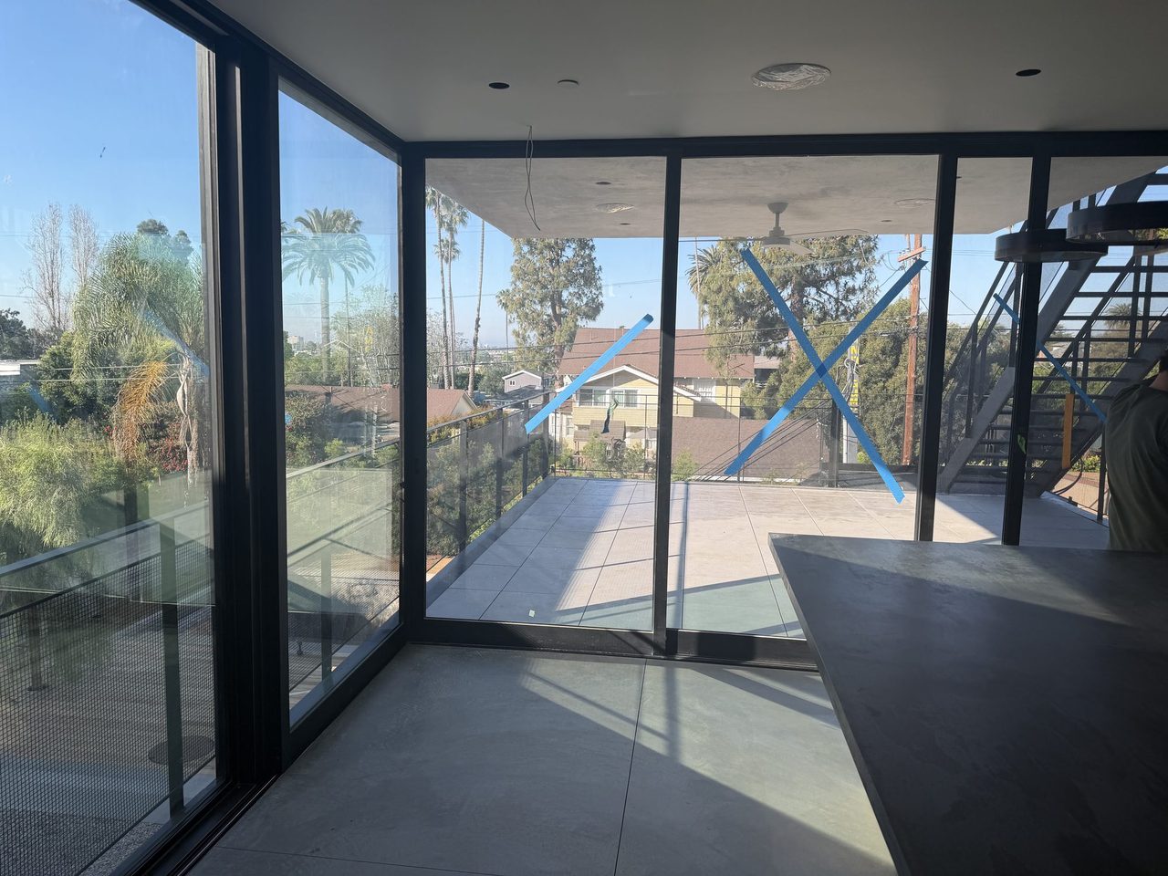 Post-construction cleaning of a newly built modern home with floor-to-ceiling glass in Los Angeles